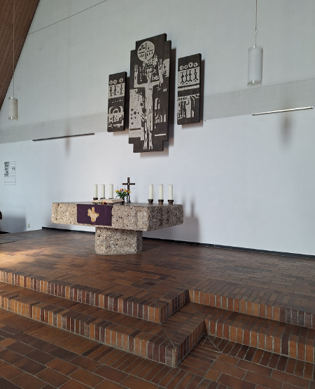 Altar der evang.-luth. Michaelskirche in Brannenburg aus 'Brannenburger Nagelfluh'. Über dem Altar eine Holzbildarbeit von Hubert Distler.